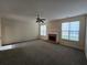 Bright living room with a brick fireplace, ceiling fan, and large windows at 4677 Liberty Square Dr, Acworth, GA 30101
