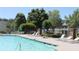 Community swimming pool surrounded by lounge chairs and lush landscaping at 4677 Liberty Square Dr, Acworth, GA 30101
