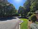 Tree-lined street with lush landscaping in a quiet neighborhood at 4677 Liberty Square Dr, Acworth, GA 30101