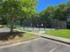 Fenced tennis court with a parking area and lush greenery at 4677 Liberty Square Dr, Acworth, GA 30101