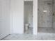 Modern bath with white marble tile shower, new fixtures, and tile flooring at 816 Ivy Ridge Dr, Loganville, GA 30052