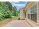 Relaxing backyard featuring a concrete patio area and green space for outdoor enjoyment at 965 Under Ct, Sugar Hill, GA 30518