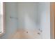 A standalone bathtub beneath a window in the light blue bathroom at 965 Under Ct, Sugar Hill, GA 30518