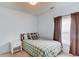 Cozy bedroom featuring a bed, side table, and window with curtains at 965 Under Ct, Sugar Hill, GA 30518