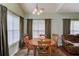 Bright dining space with a wood table, seating for six, and large windows at 965 Under Ct, Sugar Hill, GA 30518