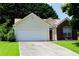Charming home featuring a two-car garage, brick accents, and a well-maintained lawn at 965 Under Ct, Sugar Hill, GA 30518