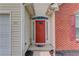Close-up of a vibrant red front door with decorative glass accents and sidelights at 965 Under Ct, Sugar Hill, GA 30518