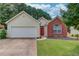 Charming single-Gathering home with a two-car garage and manicured front lawn at 965 Under Ct, Sugar Hill, GA 30518