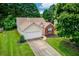 Charming single-Gathering home with a two-car garage and well-manicured front lawn at 965 Under Ct, Sugar Hill, GA 30518