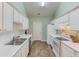 Clean kitchen featuring countertops, appliances, and abundant cabinetry at 965 Under Ct, Sugar Hill, GA 30518