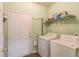 Laundry room featuring a washer, dryer, shelving, and an exterior door at 965 Under Ct, Sugar Hill, GA 30518