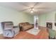 Cozy living room featuring a fireplace, plush seating, and a ceiling fan at 965 Under Ct, Sugar Hill, GA 30518