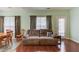 Cozy living room featuring a comfortable sofa and an adjacent dining area at 965 Under Ct, Sugar Hill, GA 30518