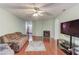 Bright living room with a fireplace, hardwood floors, and a view of the entry at 965 Under Ct, Sugar Hill, GA 30518