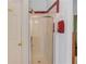 A stand-up shower with red tile trim in the corner of the bathroom at 965 Under Ct, Sugar Hill, GA 30518