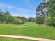 Scenic view of a well-maintained golf course with rolling green hills and mature trees at 10320 Crescent Ridge Dr, Roswell, GA 30076