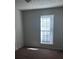 Cozy bedroom with brown carpet and a window with blinds for privacy at 1843 Grove Way, Hampton, GA 30228