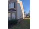 Brick and vinyl siding exterior with manicured lawn and landscaping at 1843 Grove Way, Hampton, GA 30228