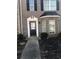 Charming brick home featuring a classic front door with decorative trim and a well-maintained front yard at 1843 Grove Way, Hampton, GA 30228