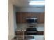 Modern kitchen with stainless steel appliances and a double basin sink at 1843 Grove Way, Hampton, GA 30228