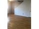 Open-concept living room with hardwood floors, showcasing ample space and a staircase at 1843 Grove Way, Hampton, GA 30228