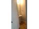 A half bathroom featuring a pedestal sink and hardwood floors at 1843 Grove Way, Hampton, GA 30228