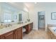Bathroom featuring double vanity with large mirror and tile flooring at 2313 Saint Davids Nw Sq # 12, Kennesaw, GA 30152