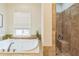 Bathroom showcases a soaking tub next to a tiled walk-in shower at 2313 Saint Davids Nw Sq # 12, Kennesaw, GA 30152