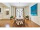 Bright dining room features hardwood floors, modern lighting, and a large window with beautiful curtains at 2313 Saint Davids Nw Sq # 12, Kennesaw, GA 30152