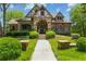 Stunning home with stone and brick facade, arched entryway, and meticulously landscaped front yard at 2313 Saint Davids Nw Sq # 12, Kennesaw, GA 30152