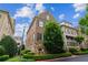 Beautiful brick exterior showcasing lush landscaping and mature trees in a desirable community at 2313 Saint Davids Nw Sq # 12, Kennesaw, GA 30152