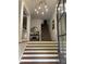 Bright foyer with a modern chandelier, staircase, and classic decor, creating a welcoming entrance at 2313 Saint Davids Nw Sq # 12, Kennesaw, GA 30152