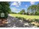 Scenic view of the golf course at a community with lush greenery, trees, and a paved cart path at 2313 Saint Davids Nw Sq # 12, Kennesaw, GA 30152