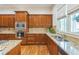 Traditional kitchen with stainless steel appliances, granite countertops, and hardwood floors at 2313 Saint Davids Nw Sq # 12, Kennesaw, GA 30152