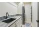 Laundry room with sink, grey granite countertop, and stacked washer/dryer at 2313 Saint Davids Nw Sq # 12, Kennesaw, GA 30152
