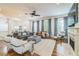 Open-concept living room with hardwood floors, a fireplace, large windows, and modern decor at 2313 Saint Davids Nw Sq # 12, Kennesaw, GA 30152