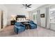 Spacious bedroom featuring plush chairs, ceiling fan, and natural lighting at 2313 Saint Davids Nw Sq # 12, Kennesaw, GA 30152