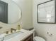 Stylish powder room with a modern round mirror, elegant fixtures, and minimalist decor at 2313 Saint Davids Nw Sq # 12, Kennesaw, GA 30152