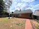 A spacious backyard showcases a red brick trim path, patio, basketball hoop, and privacy fence at 3625 Ennfield Ln, Duluth, GA 30096