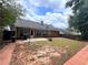 Backyard features a patio, basketball hoop and lots of grass, surrounded by wooden fencing and mature trees at 3625 Ennfield Ln, Duluth, GA 30096