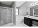 Bathroom featuring tub, glass shower, double vanity, and neutral color palette at 3625 Ennfield Ln, Duluth, GA 30096