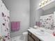 Neutral bathroom featuring a white vanity and floral shower curtain, offering a clean and modern space at 3625 Ennfield Ln, Duluth, GA 30096