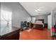Bedroom features wood floors, large bed, vaulted ceilings, ceiling fan, and desk area at 3625 Ennfield Ln, Duluth, GA 30096