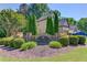 A beautifully landscaped stone sign welcomes you to the Ennfield community in a serene, wooded setting at 3625 Ennfield Ln, Duluth, GA 30096