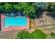 Aerial view of the community pool, surrounded by lush trees and next to the community playground at 3625 Ennfield Ln, Duluth, GA 30096