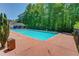 Enjoy the community pool featuring a large pool deck, lounging area, and adjacent wooden trash can at 3625 Ennfield Ln, Duluth, GA 30096