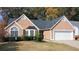 Close up of a well-maintained home with manicured shrubbery and a two car garage at 3625 Ennfield Ln, Duluth, GA 30096