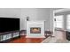 Living room fireplace with marble hearth, hardwood floors, and natural light at 3625 Ennfield Ln, Duluth, GA 30096