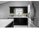 Kitchen area featuring dark cabinetry, stainless steel appliances, light countertops, and mosaic tile backsplash at 3625 Ennfield Ln, Duluth, GA 30096
