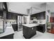 Modern kitchen featuring dark cabinetry, stainless steel appliances, and a center island at 3625 Ennfield Ln, Duluth, GA 30096